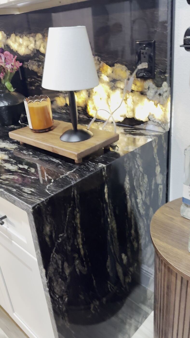 Stone Experience finished countertop corner detail, warm lighting