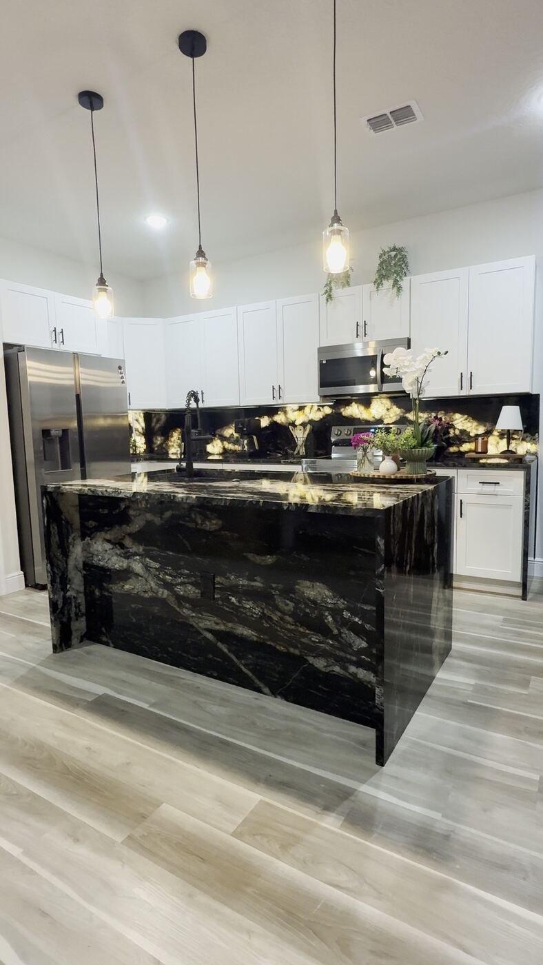 Finished Stone Experience kitchen with custom waterfall island