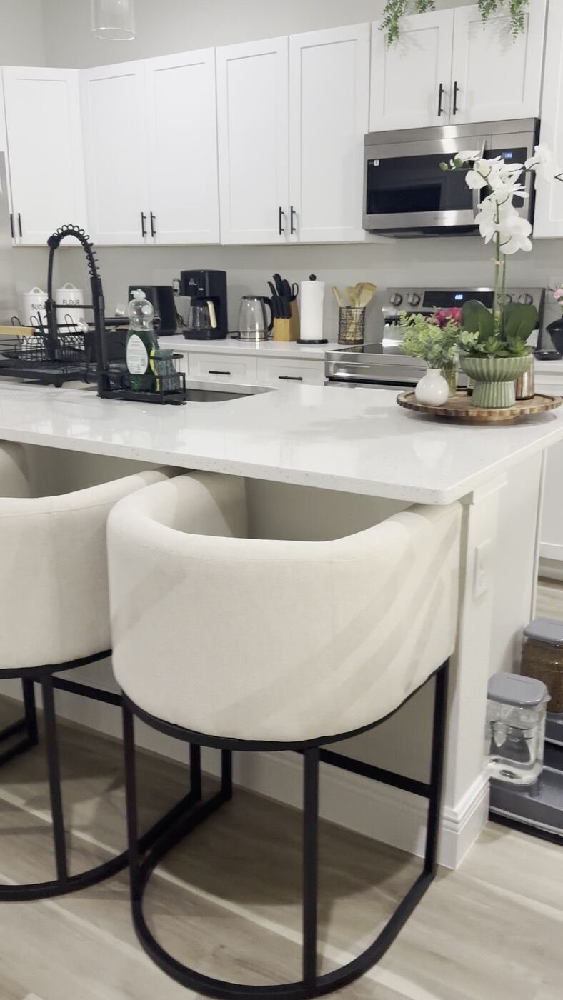 Kitchen remodel with white quartz countertop and barstool seating