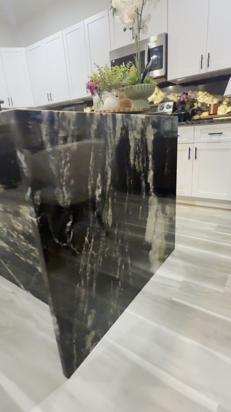 Waterfall edge detail on a Stone Experience countertop, showing natural stone movement